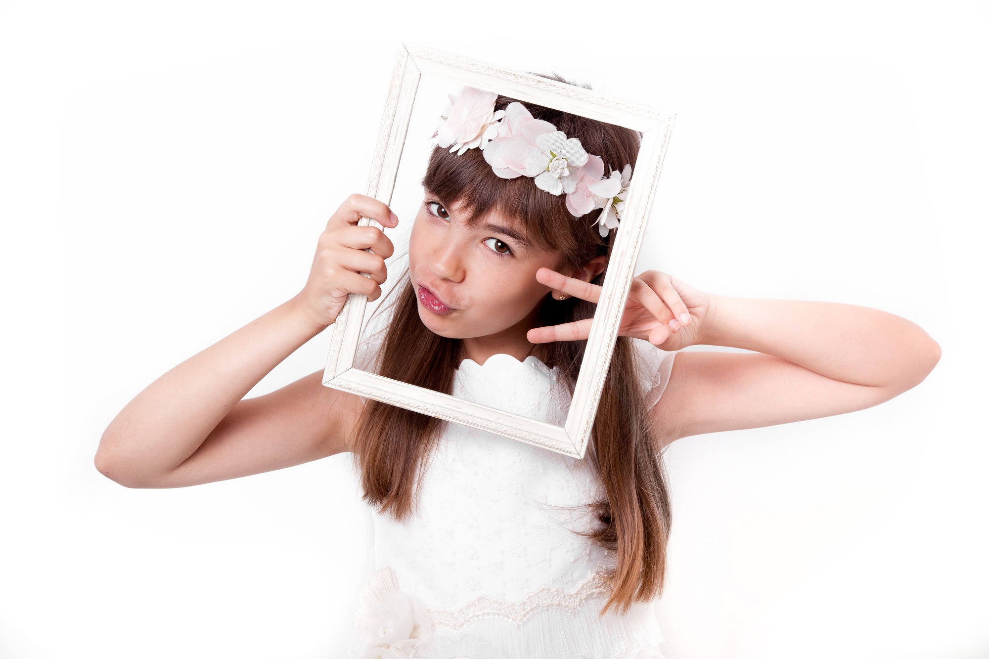 Communion girl grimacing with a frame on her face